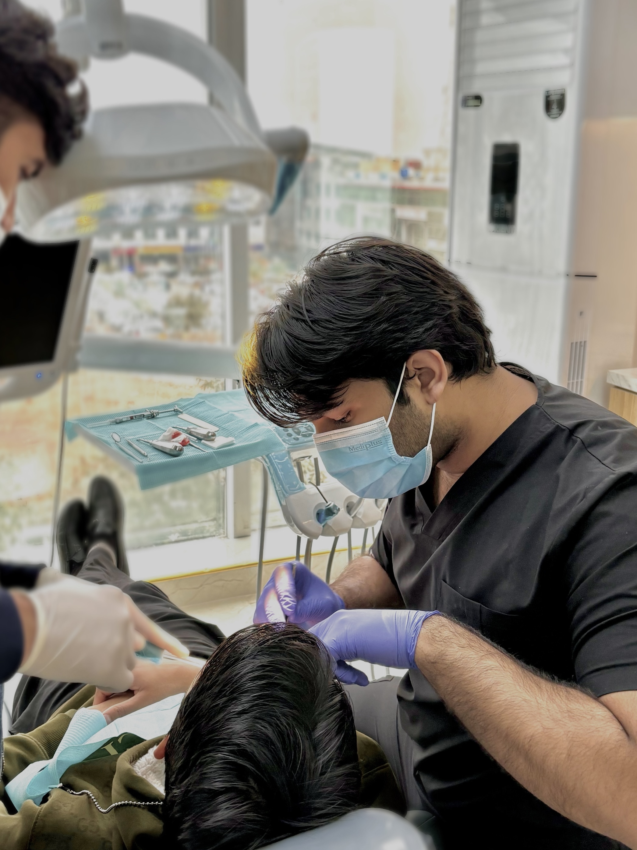 A friendly male dentist consulting with a happy female patient